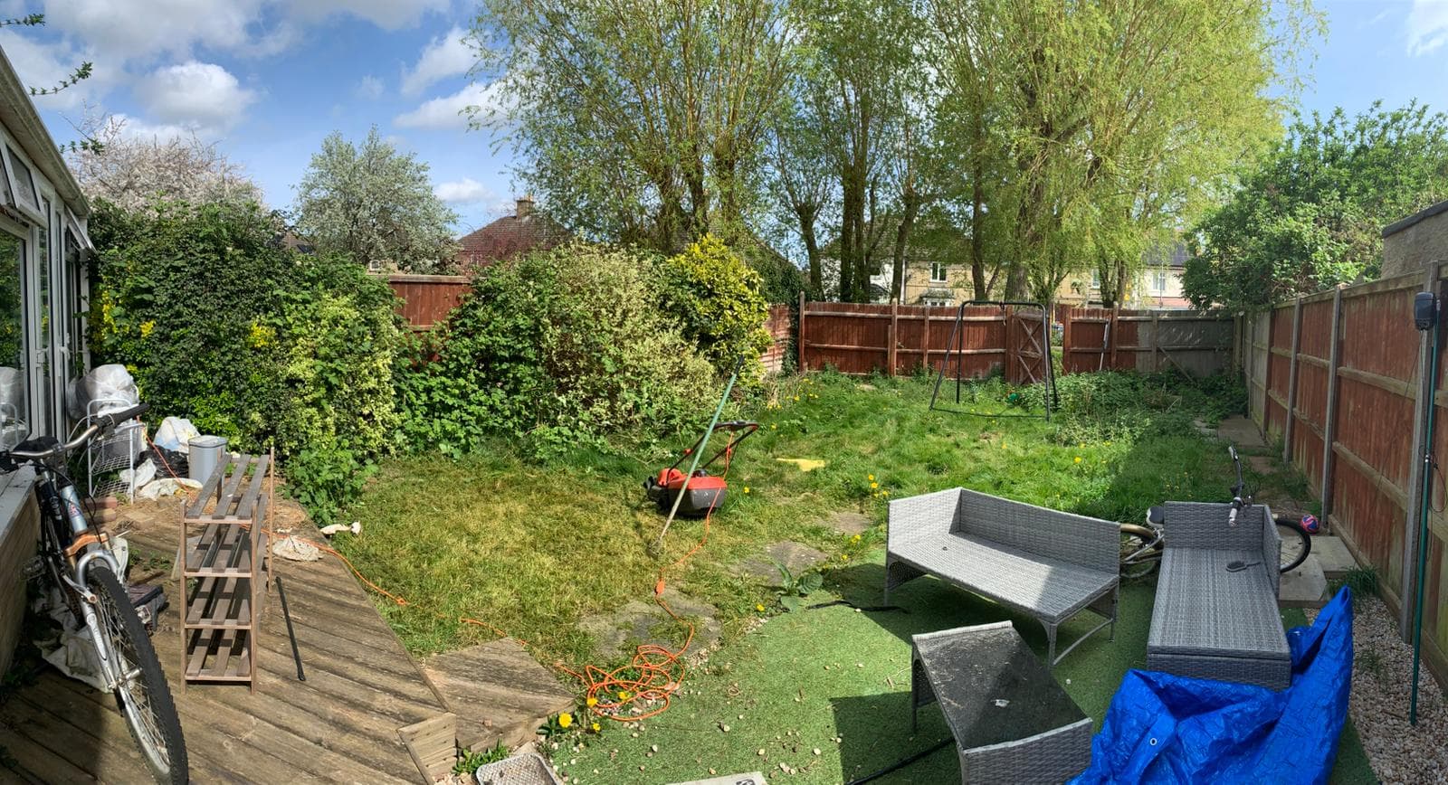 Same rear garden part-way through clearance with vegetation cut back